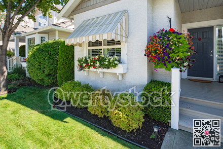 Window and main entrance of residential house with door steps on sunny day