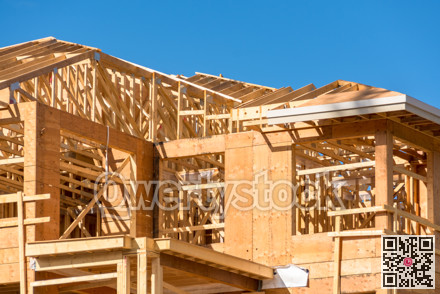 New apartment building under construction on sunny day on blue sky background.