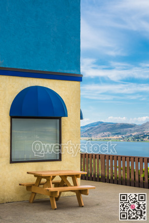 Cafe place with wooden table and view on Okanagan lake