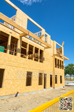 Low rise wooden framework of the building on concrete base
