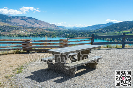 Concrete table with benches on picnic area with great view on Kalamaka lake