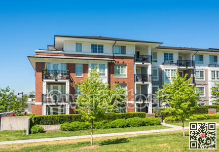 Brand new low rise apartment building on sunny day in British Columbia, Canada.