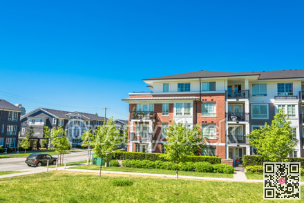 Brand new low rise apartment building on sunny day in British Columbia, Canada.