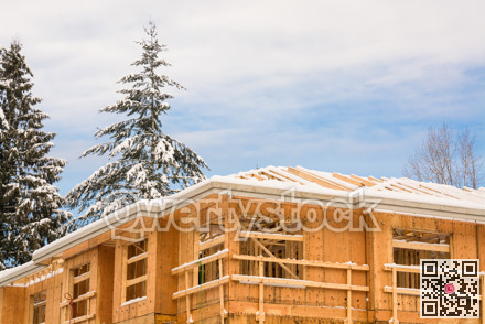 Fragment of townhome complex under construction on winter time.