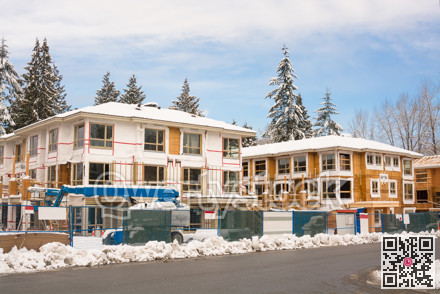Townhome complex under construction in snow