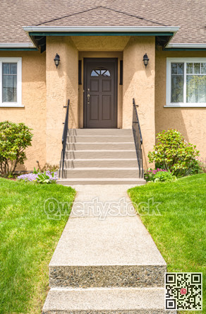 Main entrance of old family house with concrete pathway over front yard