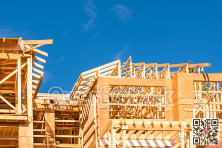 Wood frame building under construction on blue sky background