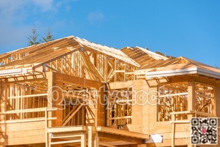 New apartment building under construction on sunny day on blue sky background.