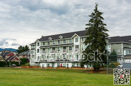 New residential low-rise building with huge green lawn in front