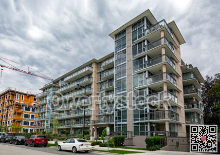New residential low-rise building with cars parked on the street