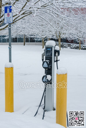 EV charging station for zero emission cars on white snow background
