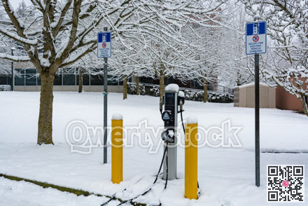 EV charging station for zero emission cars on white snow background