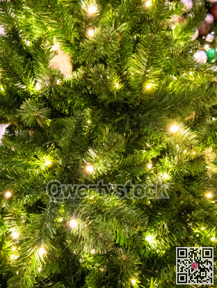 Green Christmass tree fir texture with lights and balls background.