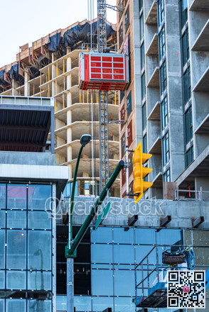 High-rise buildings under constraction with external elevator on the wall