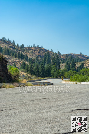 Asphalt road leading uphill to the mountains.