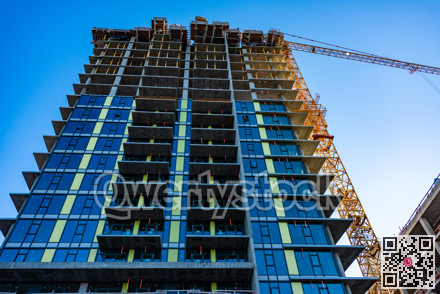 Monolite concrete building under constraction on blue sky background.
