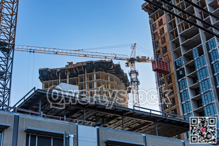 High-rise buildings under constraction with external elevator on the wall