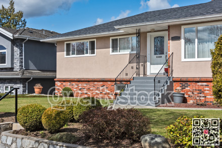 Average single family house with front yard on land terrace
