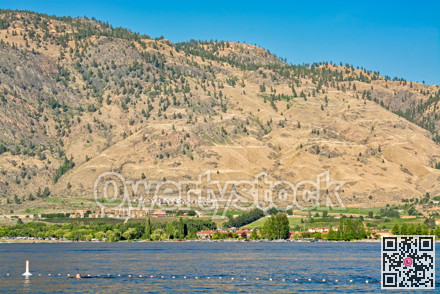 Swimming area of Okanagan lake view with mountain on the background