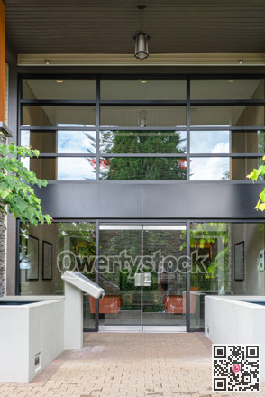 Entrance of new residential building with paved area in front