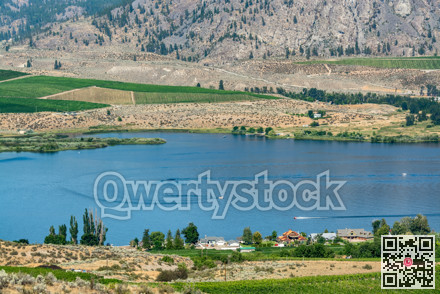 Okanagan valley scenery view with residential area and orchard farm fields