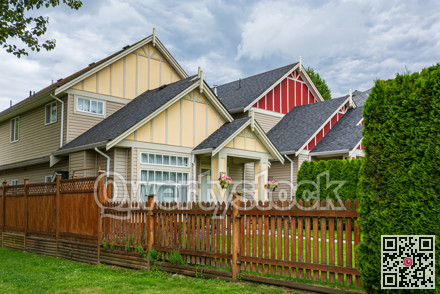 A perfect neighbourhood. Colorful residential houses with wooden fence in front
