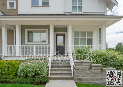 Entrance of residential unit under the porch with doorsteps in front