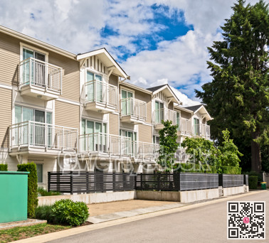 Back yard of residential townhouses on bright sunny day