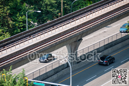 Cityscape. Fragment of four lane road with skytrain path over