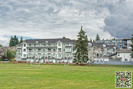 New residential low-rise building with huge green lawn in front
