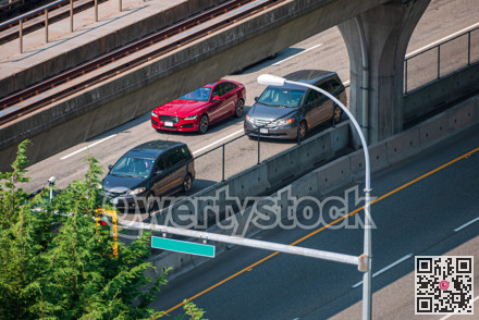 Cityscape. Fragment of four lane road with skytrain rail path above