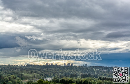 Scenery view of sity in the park on cloudy sky background
