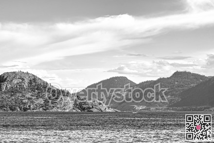 Scenery view of rocky slope over the lake in black and white