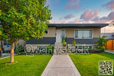 Average family house with concrete pathway over front yard