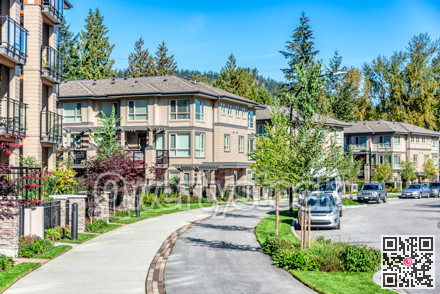 Paved pathway along residential building on sunny day