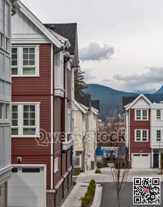 Pathway in a block of residential townhouses with overcast sky background