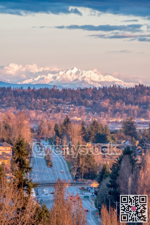 Empty city street in sunset light with mountain Baker on the background