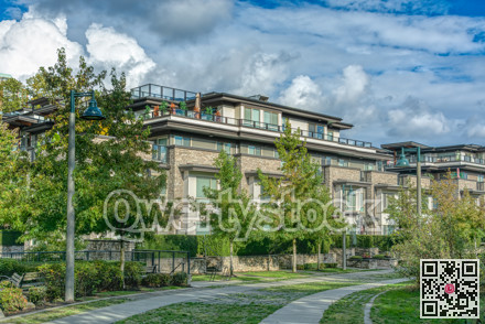 Residential apartment building on cloudy sky background