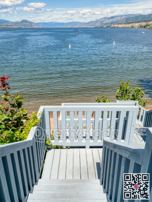 Big lake overview with wooden stairway to the beach on the shore
