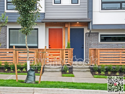 Red and blue doors of brand new residential townhouses