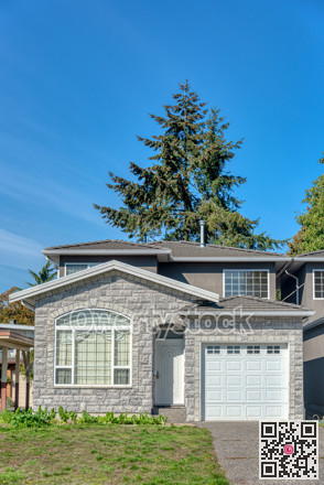 Half of residential duplex house on bright sunny day