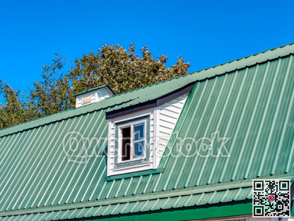 Top roof of old farm barn on blue sky background