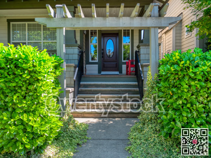 Porch with red chair and entrance of residential house
