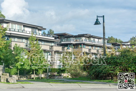 Residential apartment buildings on cloudy sky background