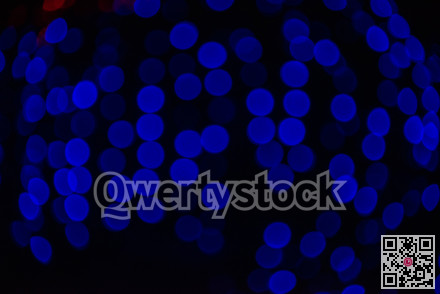 Group of blue holiday lights on dark background of night