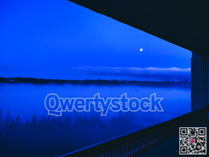 Cityscape in the night with full moon in the sky