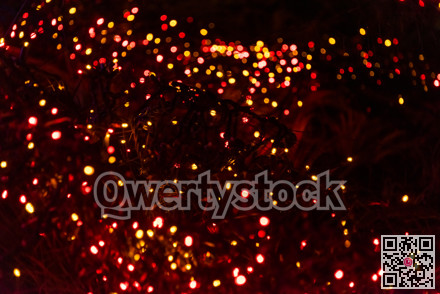 Colorful holiday lights on dark background of night