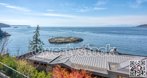 Pacific ocean bay overview with roof of residential house in front