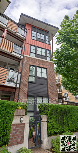 Corner tower of residential building with individual gate on the ground level
