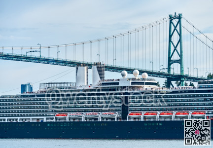 Close up view on huge ocean cruise ship passing famous Lion Gates Bridge
